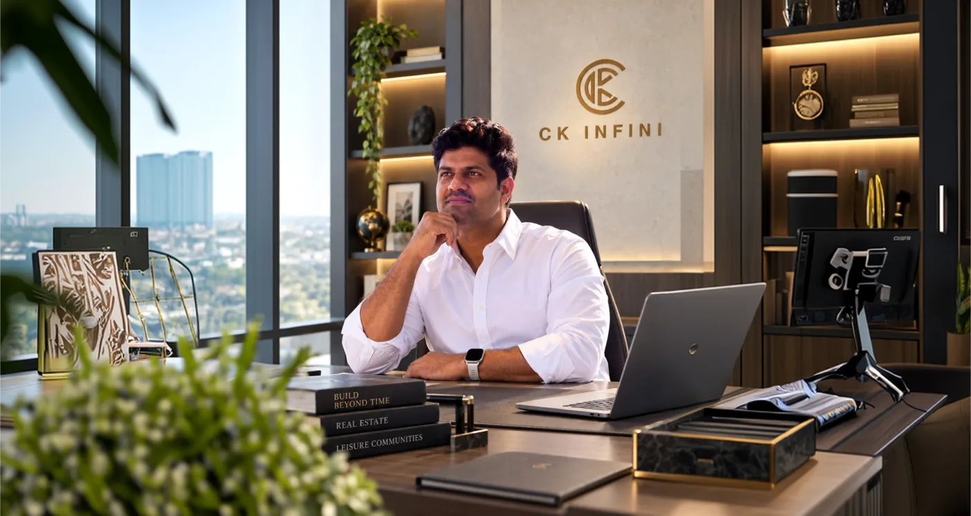 Director smiling while speaking on a phone outside a glass building